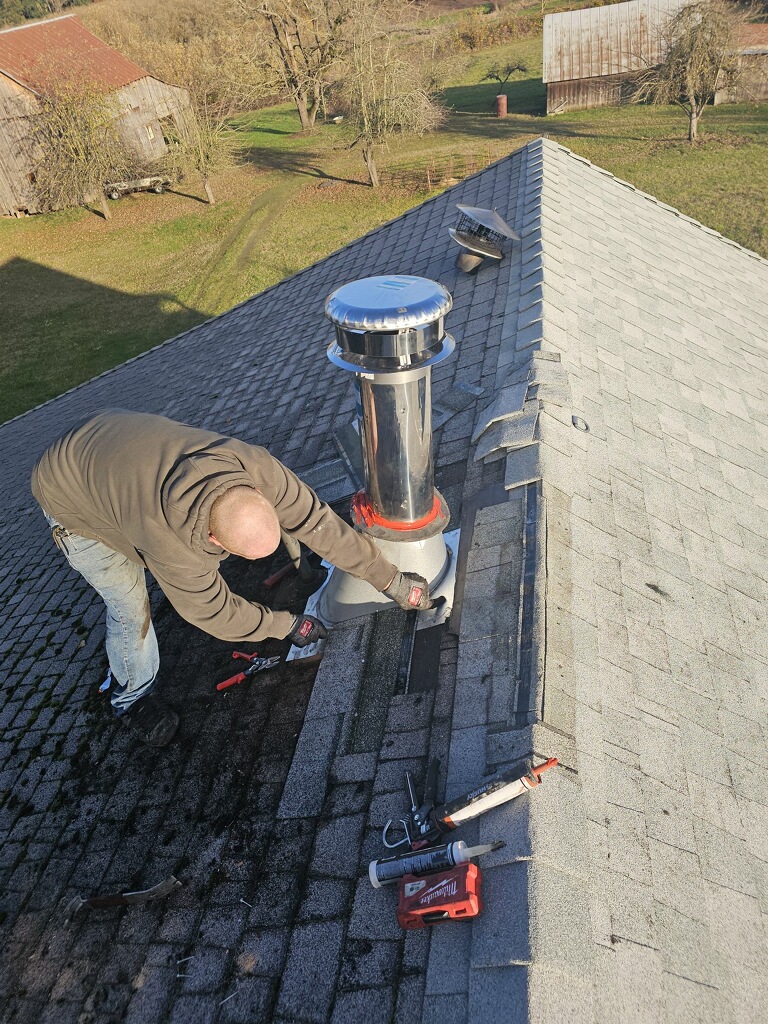 Chimney technician installing a chimney cap